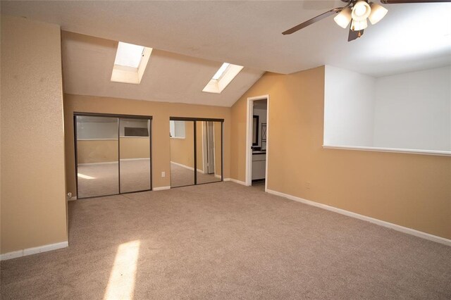 16800 Sugar Pine Dr Unit F44, Houston, TX 77090 - unfurnished bedroom featuring a skylight, carpet flooring, lofted ceiling, two closets, and baseboards