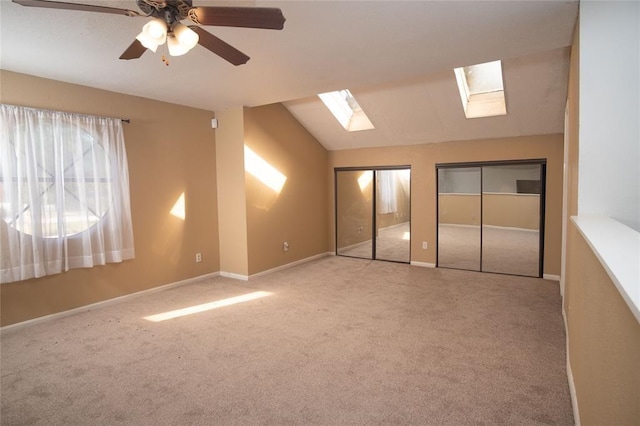 16800 Sugar Pine Dr Unit F44, Houston, TX 77090 - unfurnished bedroom featuring a skylight, carpet, multiple closets, vaulted ceiling, and ceiling fan
