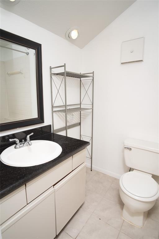 16800 Sugar Pine Dr Unit F44, Houston, TX 77090 - bathroom featuring vanity, toilet, baseboards, and tile patterned flooring