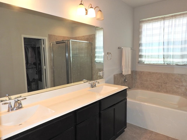 2705 Osprey Ln, Pearland, TX 77581 - bathroom featuring a bath, a stall shower, double vanity, tile patterned flooring, and a walk in closet