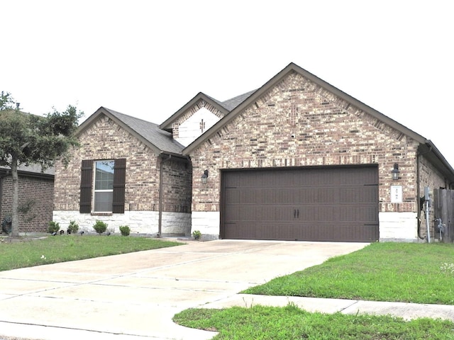 2705 Osprey Ln, Pearland, TX 77581 - view of front of property with brick siding, a garage, driveway, and a front yard