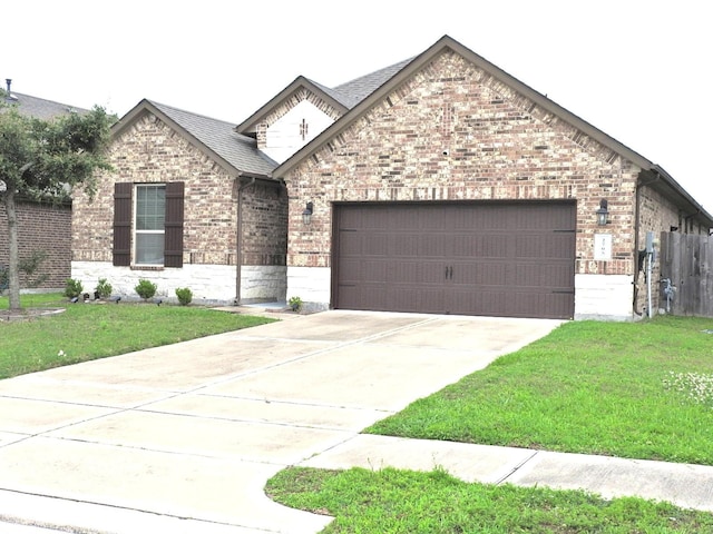 2705 Osprey Ln, Pearland, TX 77581 - view of front of house featuring a garage, brick siding, concrete driveway, roof with shingles, and stone siding