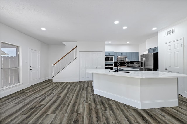 1826 Cheyenne River Cir, Sugar Land, TX 77478 - kitchen with appliances with stainless steel finishes, dark wood finished floors, a large island, recessed lighting, and a sink