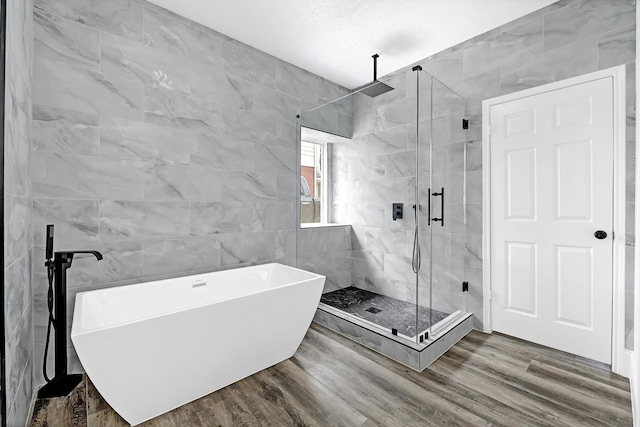 1826 Cheyenne River Cir, Sugar Land, TX 77478 - full bath with a freestanding tub, a stall shower, wood finished floors, and tile walls