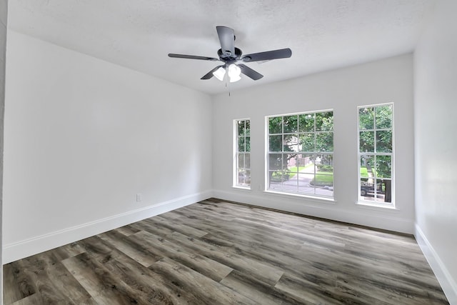 1826 Cheyenne River Cir, Sugar Land, TX 77478 - spare room featuring baseboards, dark wood-style floors, and a ceiling fan
