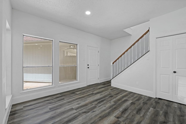 1826 Cheyenne River Cir, Sugar Land, TX 77478 - entrance foyer featuring stairs, dark wood-type flooring, a textured ceiling, baseboards, and recessed lighting