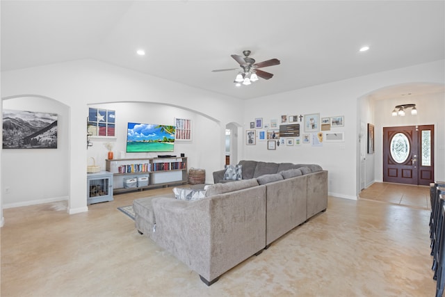 10711 Indian Trails Dr, Tomball, TX 77375 - living room featuring arched walkways, ceiling fan, recessed lighting, baseboards, and lofted ceiling