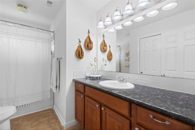 10711 Indian Trails Dr, Tomball, TX 77375 - bathroom with vanity, toilet, and backsplash