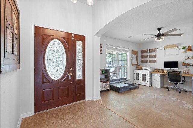 10711 Indian Trails Dr, Tomball, TX 77375 - foyer entrance featuring arched walkways, ceiling fan, and baseboards
