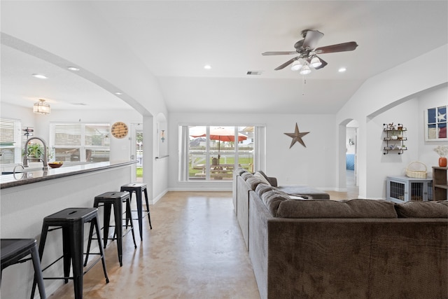 10711 Indian Trails Dr, Tomball, TX 77375 - living area with arched walkways, lofted ceiling, finished concrete floors, a ceiling fan, and recessed lighting