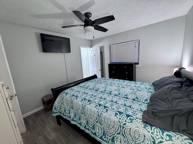 219 Lakeside Dr, Kemah, TX 77565 - bedroom featuring wood finished floors, baseboards, a textured ceiling, and a ceiling fan