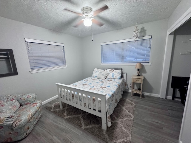 219 Lakeside Dr, Kemah, TX 77565 - bedroom with a textured ceiling, baseboards, wood finished floors, and a ceiling fan