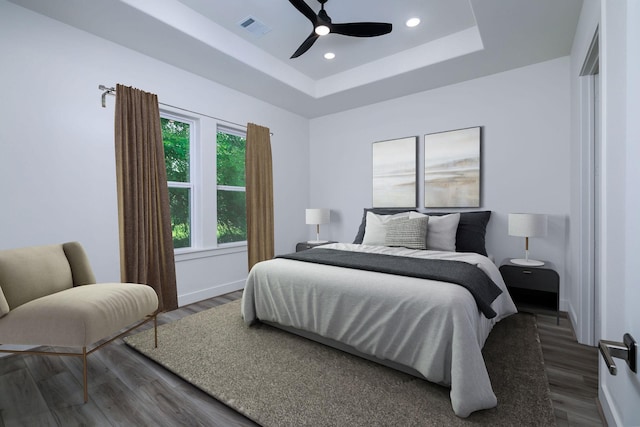 68 Fairway Dr, Trinity, TX 75862 - bedroom featuring wood finished floors, a raised ceiling, ceiling fan, recessed lighting, and baseboards
