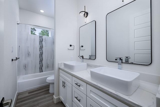 68 Fairway Dr, Trinity, TX 75862 - bathroom featuring toilet, double vanity, bathtub / shower combination, wood finished floors, and recessed lighting