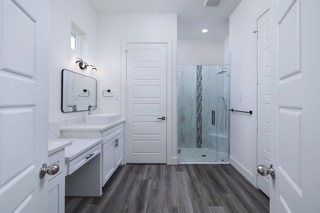 68 Fairway Dr, Trinity, TX 75862 - full bathroom featuring vanity, a marble finish shower, wood finished floors, recessed lighting, and baseboards