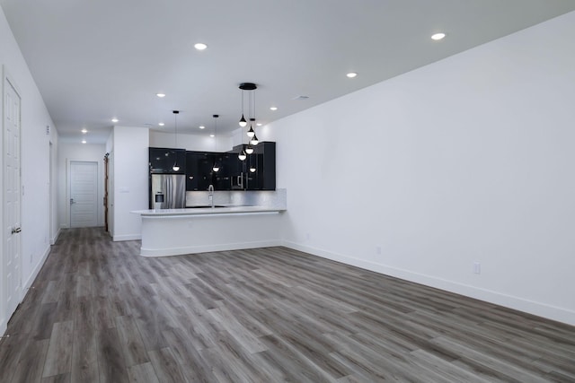 68 Fairway Dr, Trinity, TX 75862 - unfurnished living room with recessed lighting, wood finished floors, baseboards, and a sink