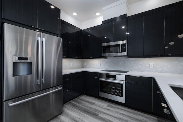68 Fairway Dr, Trinity, TX 75862 - kitchen with stainless steel appliances, dark cabinets, light countertops, and recessed lighting