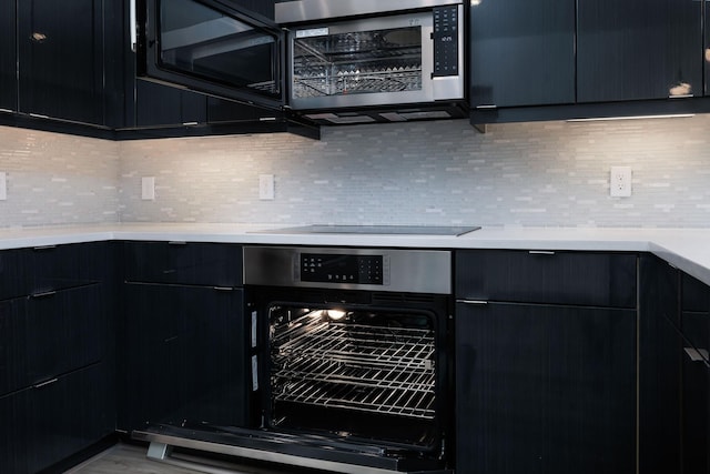 68 Fairway Dr, Trinity, TX 75862 - kitchen featuring light countertops, backsplash, and dark cabinetry
