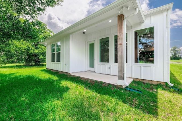 68 Fairway Dr, Trinity, TX 75862 - rear view of house featuring board and batten siding and a lawn