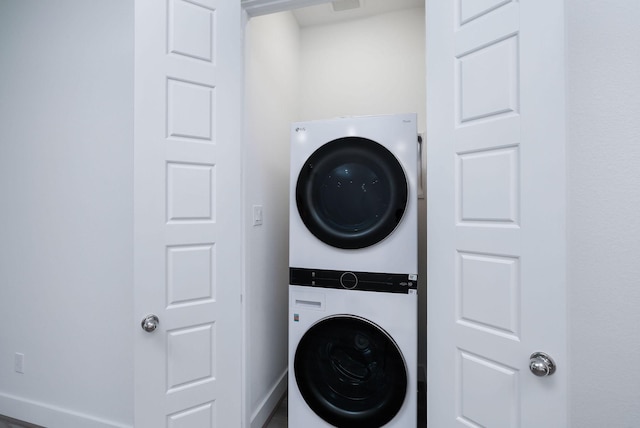 68 Fairway Dr, Trinity, TX 75862 - laundry room with stacked washer and clothes dryer and baseboards