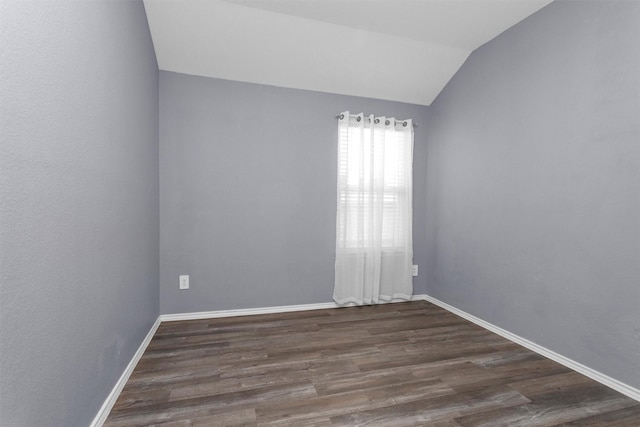 315 Coral Drift Ct, Crosby, TX 77532 - spare room with wood finished floors, lofted ceiling, and baseboards