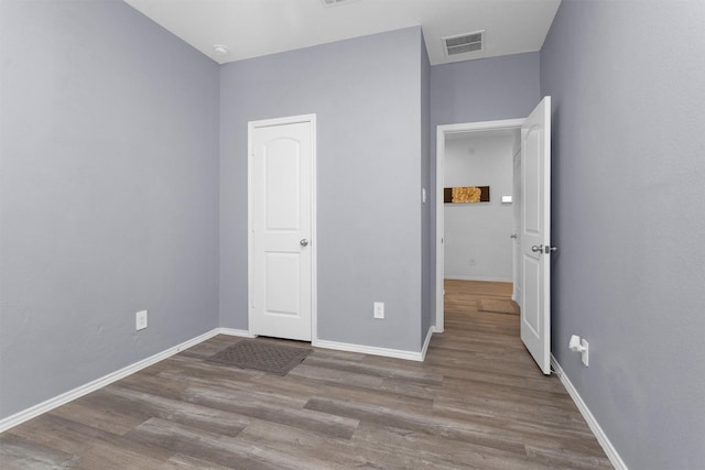 315 Coral Drift Ct, Crosby, TX 77532 - unfurnished bedroom with wood finished floors and baseboards