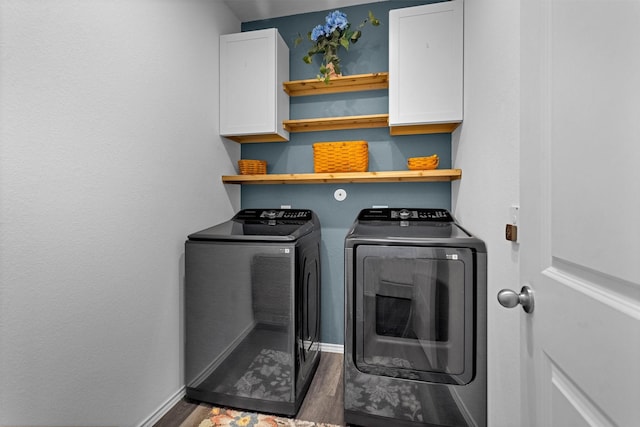 315 Coral Drift Ct, Crosby, TX 77532 - washroom featuring cabinet space, washer and dryer, wood finished floors, and baseboards