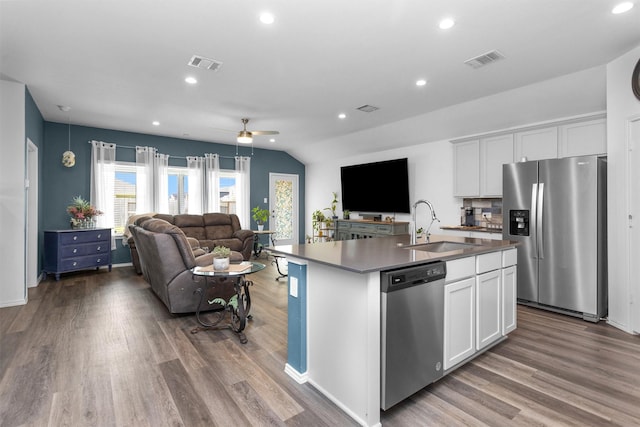 315 Coral Drift Ct, Crosby, TX 77532 - kitchen featuring stainless steel appliances, a ceiling fan, open floor plan, a sink, and wood finished floors