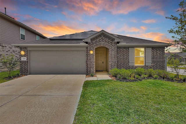 315 Coral Drift Ct, Crosby, TX 77532 - view of front of home featuring brick siding, an attached garage, a shingled roof, and roof mounted solar panels