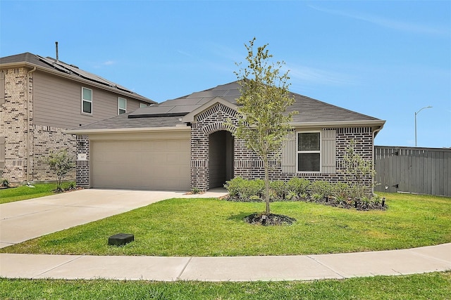 315 Coral Drift Ct, Crosby, TX 77532 - view of front of house featuring a garage, concrete driveway, roof mounted solar panels, and brick siding