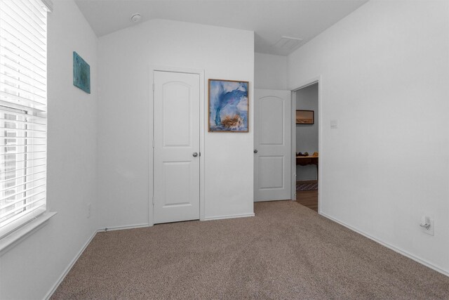 315 Coral Drift Ct, Crosby, TX 77532 - unfurnished bedroom featuring carpet floors, baseboards, and lofted ceiling