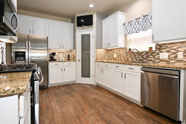 26414 Longview Creek Dr, Katy, TX 77494 - kitchen with stainless steel appliances, white cabinetry, a sink, dark wood-style floors, and recessed lighting