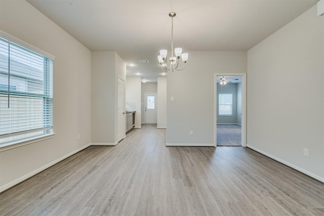 27398 Axis Deer Trl, Magnolia, TX 77354 - empty room with light wood-type flooring, a chandelier, baseboards, and a ceiling fan