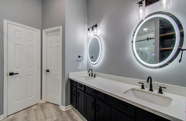 3203 Blaesser Dr, Pearland, TX 77584 - bathroom featuring wood finished floors and double vanity