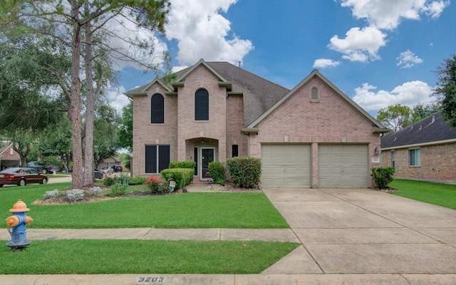 3203 Blaesser Dr, Pearland, TX 77584 - traditional-style house featuring brick siding, a garage, concrete driveway, and a front yard