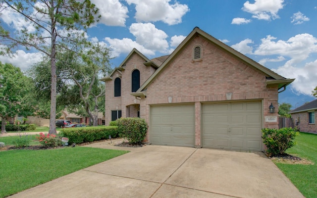 3203 Blaesser Dr, Pearland, TX 77584 - view of front of home with concrete driveway, a garage, a front yard, and brick siding