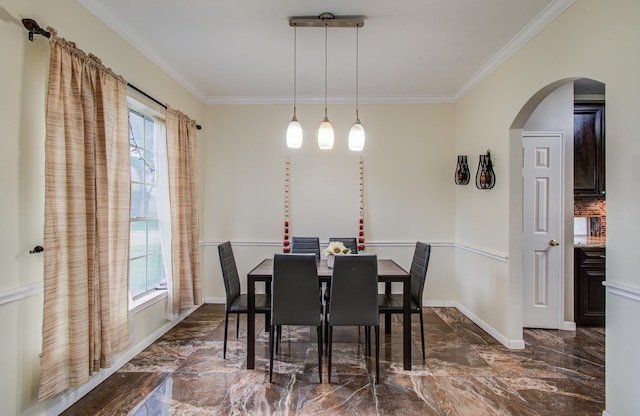 3203 Blaesser Dr, Pearland, TX 77584 - dining space with dark marble finish flooring, arched walkways, ornamental molding, and baseboards