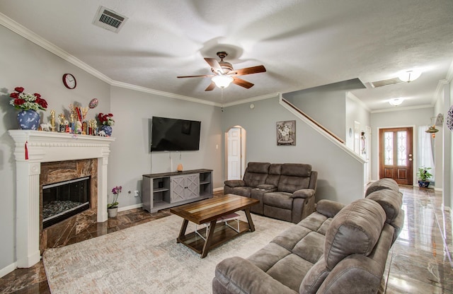3203 Blaesser Dr, Pearland, TX 77584 - living room featuring marble tiled floors, arched walkways, crown molding, stairway, and a ceiling fan