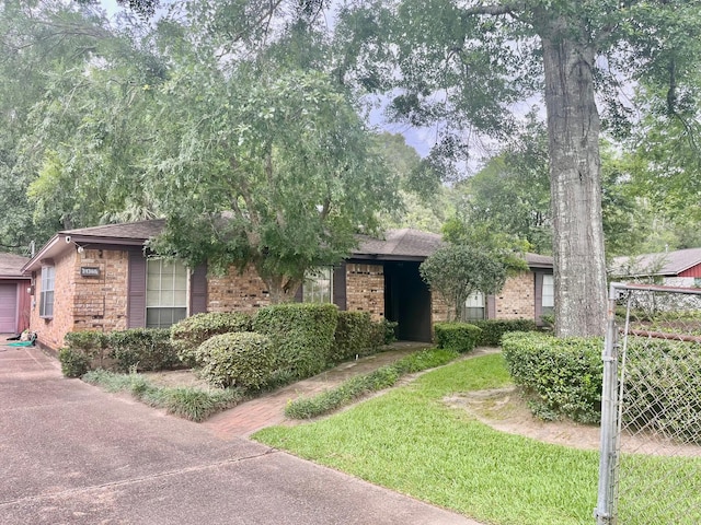 24360 Webb Rd, Porter, TX 77365 - ranch-style home featuring brick siding, concrete driveway, and a garage