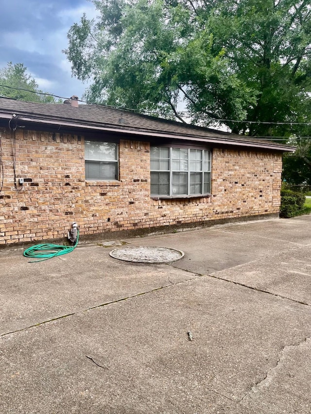 24360 Webb Rd, Porter, TX 77365 - view of property exterior with brick siding and a patio area