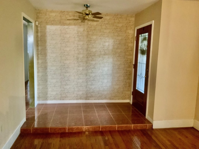 24360 Webb Rd, Porter, TX 77365 - empty room featuring baseboards, a ceiling fan, healthy amount of natural light, brick wall, and wood finished floors