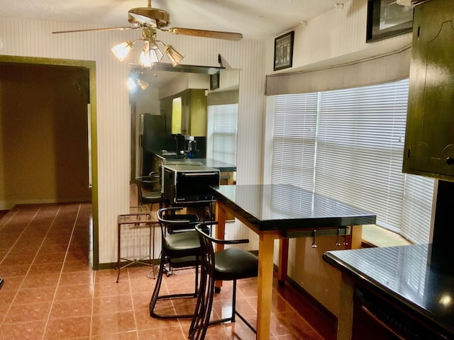 24360 Webb Rd, Porter, TX 77365 - dining area with wallpapered walls, a ceiling fan, baseboards, and tile patterned floors