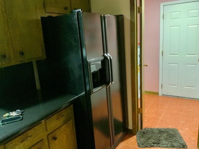 24360 Webb Rd, Porter, TX 77365 - kitchen with black refrigerator with ice dispenser, light tile patterned flooring, and baseboards