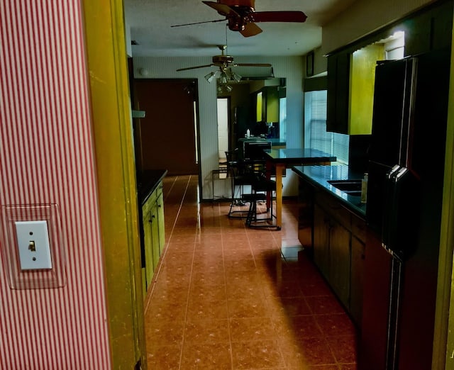 24360 Webb Rd, Porter, TX 77365 - kitchen with freestanding refrigerator, dark countertops, ceiling fan, dark tile patterned flooring, and a sink