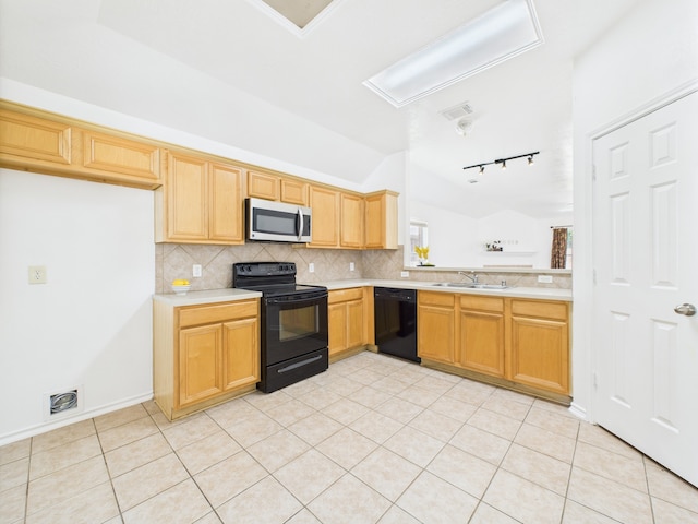 26940 Carriage Manor Ln, Kingwood, TX 77339 - kitchen featuring black appliances, vaulted ceiling, a sink, light countertops, and backsplash