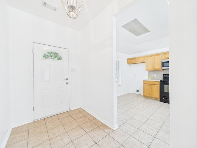 26940 Carriage Manor Ln, Kingwood, TX 77339 - entryway with light tile patterned floors and baseboards