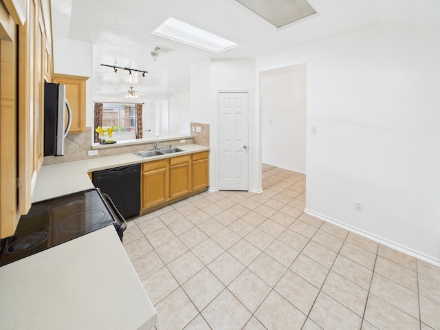 26940 Carriage Manor Ln, Kingwood, TX 77339 - kitchen featuring stainless steel microwave, dishwasher, a sink, rail lighting, and light countertops