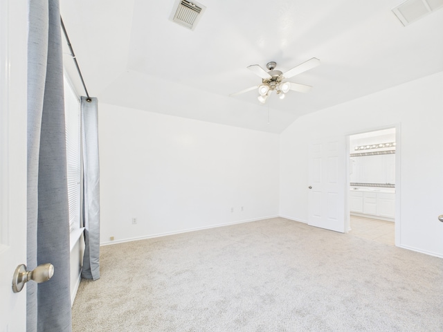 26940 Carriage Manor Ln, Kingwood, TX 77339 - empty room with light colored carpet, ceiling fan, baseboards, and vaulted ceiling