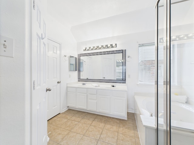 26940 Carriage Manor Ln, Kingwood, TX 77339 - bathroom with a garden tub, double vanity, tile patterned floors, baseboards, and a shower stall