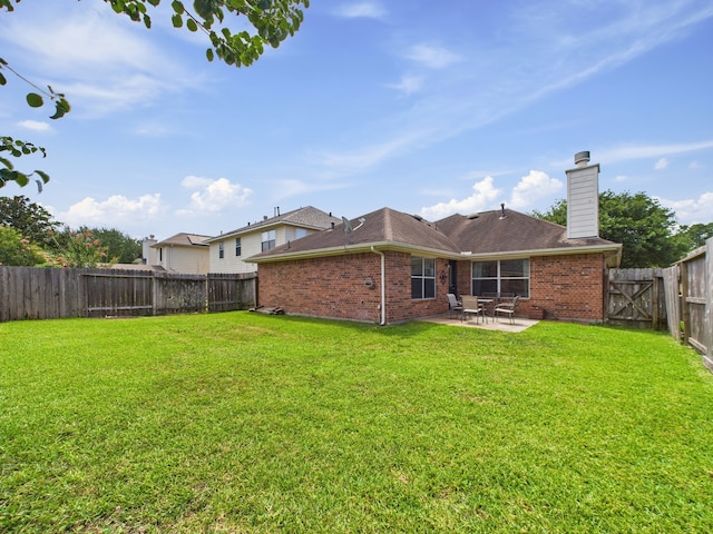 26940 Carriage Manor Ln, Kingwood, TX 77339 - back of house with brick siding, a patio, and a chimney